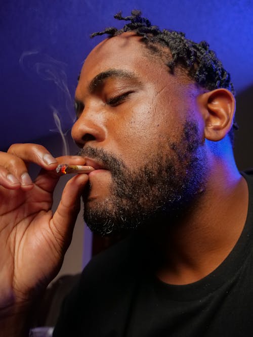 Free Close-Up Photo of Man Smoking Joint Stock Photo