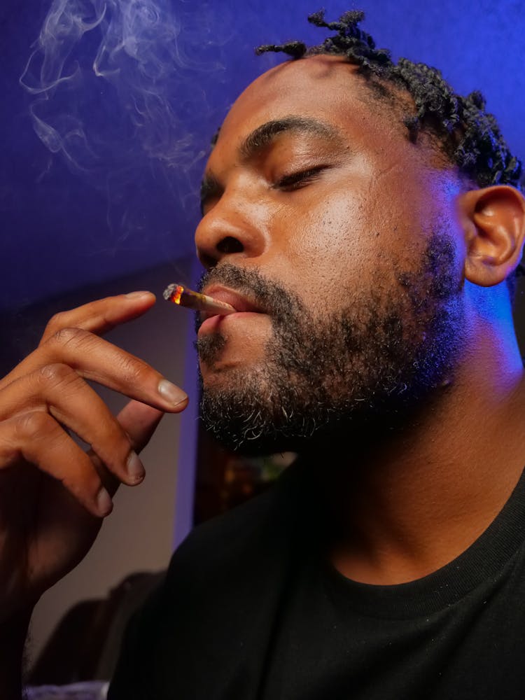 Close-Up Photo Of Man Smoking Blunt