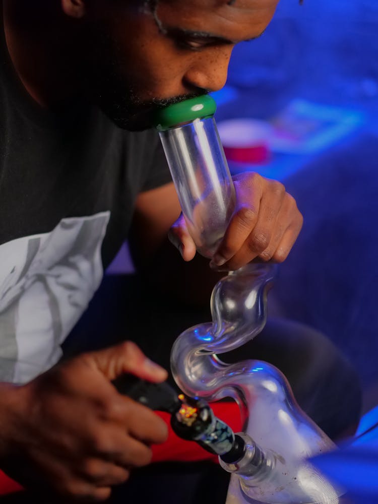 Side View Photo Of Man Using Bong In Smoking Weeds