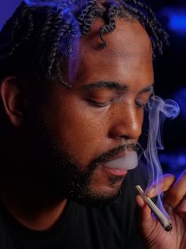 Close-Up Photo of Man Smoking Blunt