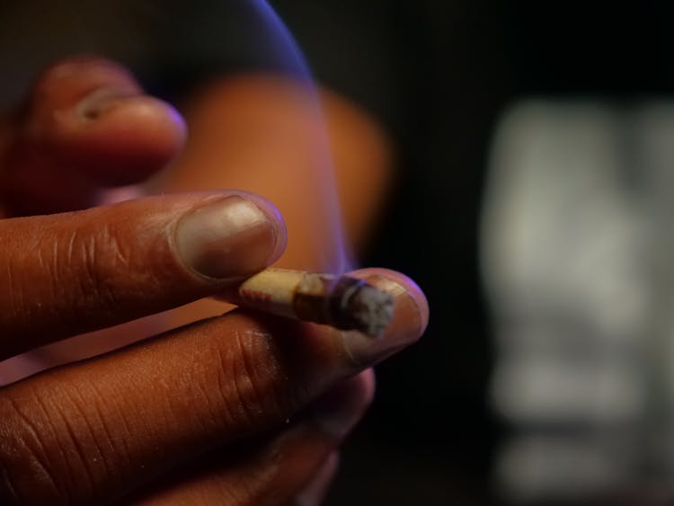 Close-Up Photo Of Person Holding Blunt