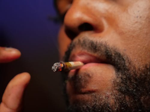 Free Close-Up Photo of Man Smoking Cigarette Stock Photo