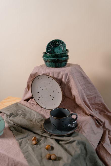 Ceramic dishes arranged with folded linen — photo by MART PRODUCTION on Pexels