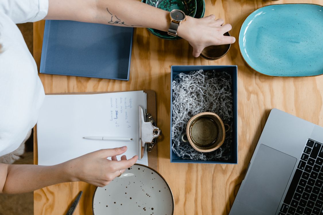 A Seller Packing Mugs · Free Stock Photo