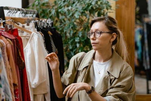 Close Up Photo of Woman Choosing Clothes