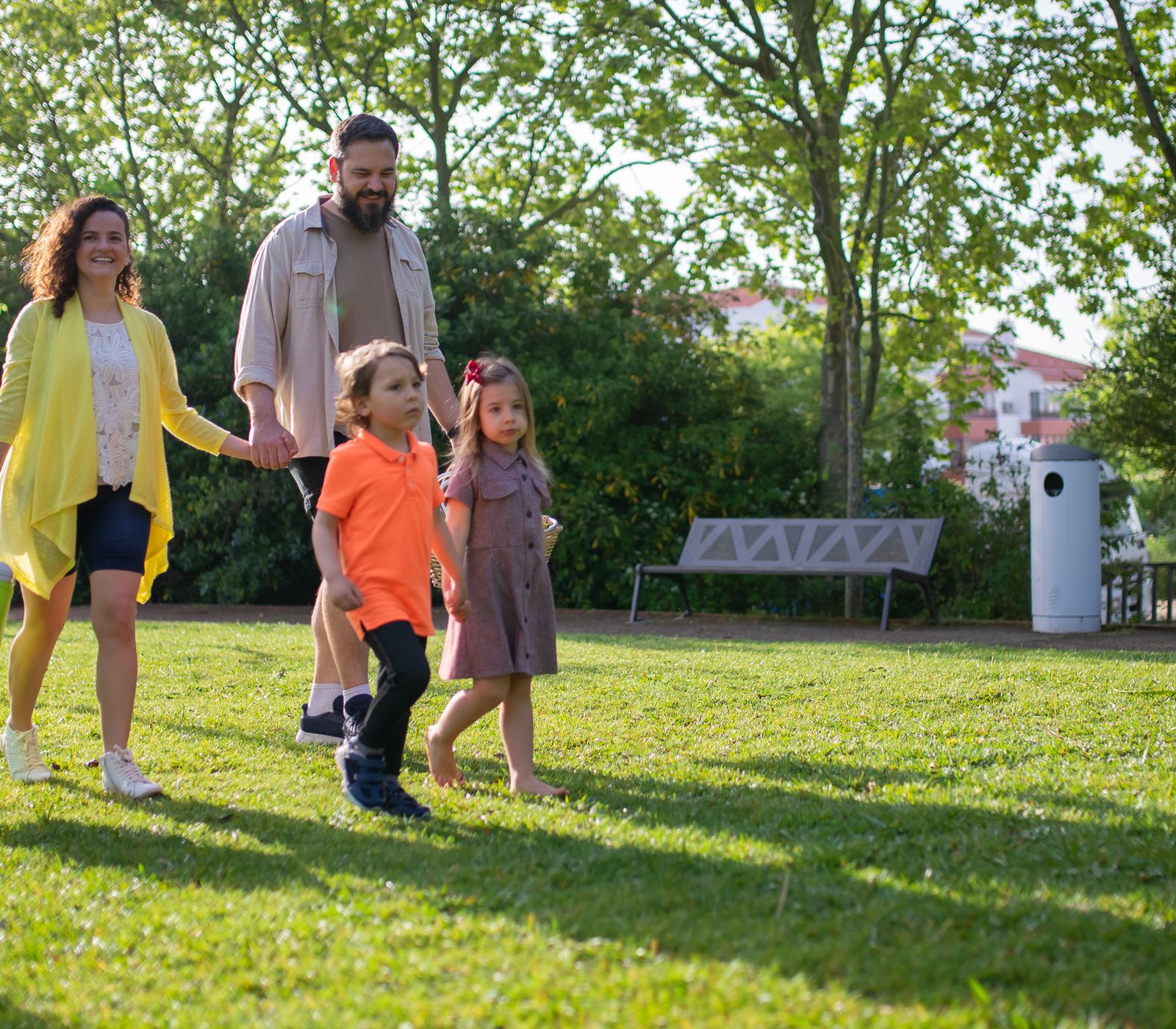 A joyful family with children strolling in a sunny Portuguese park.