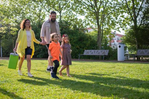 Free A joyful family with children strolling in a sunny Portuguese park. Stock Photo