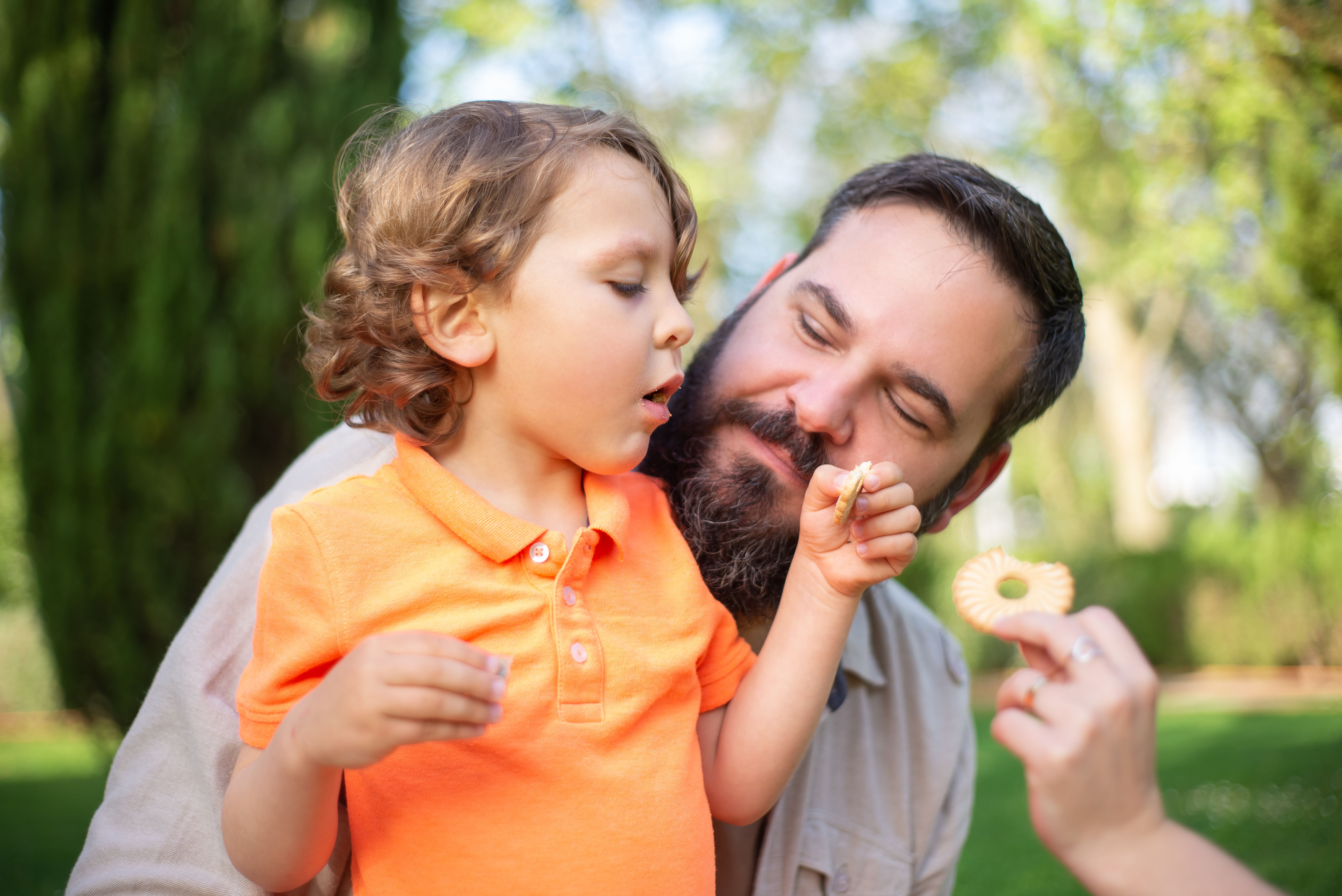 Close-up of father and son sharing a bonding moment outdoors in Portugal.