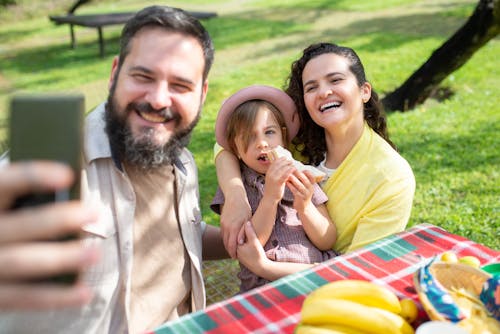 Man Taking Selfie with Family