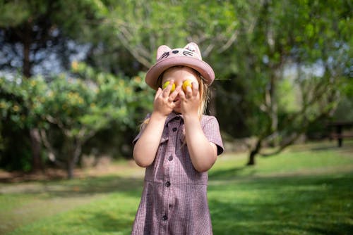 Girl in Cat Hat Covering Face