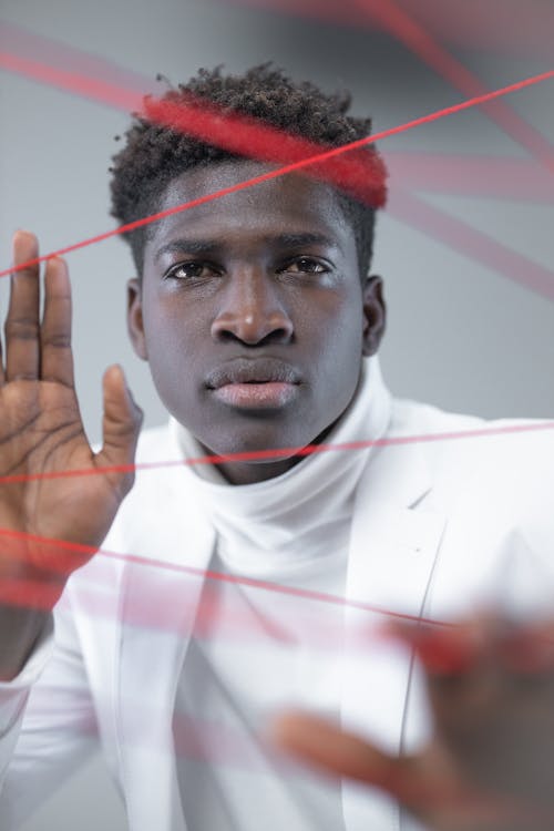 Free A Man Posing with Red Threads Stock Photo