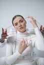 Woman in White Turtleneck Sweater Holding Red Plastic Clothes Hanger