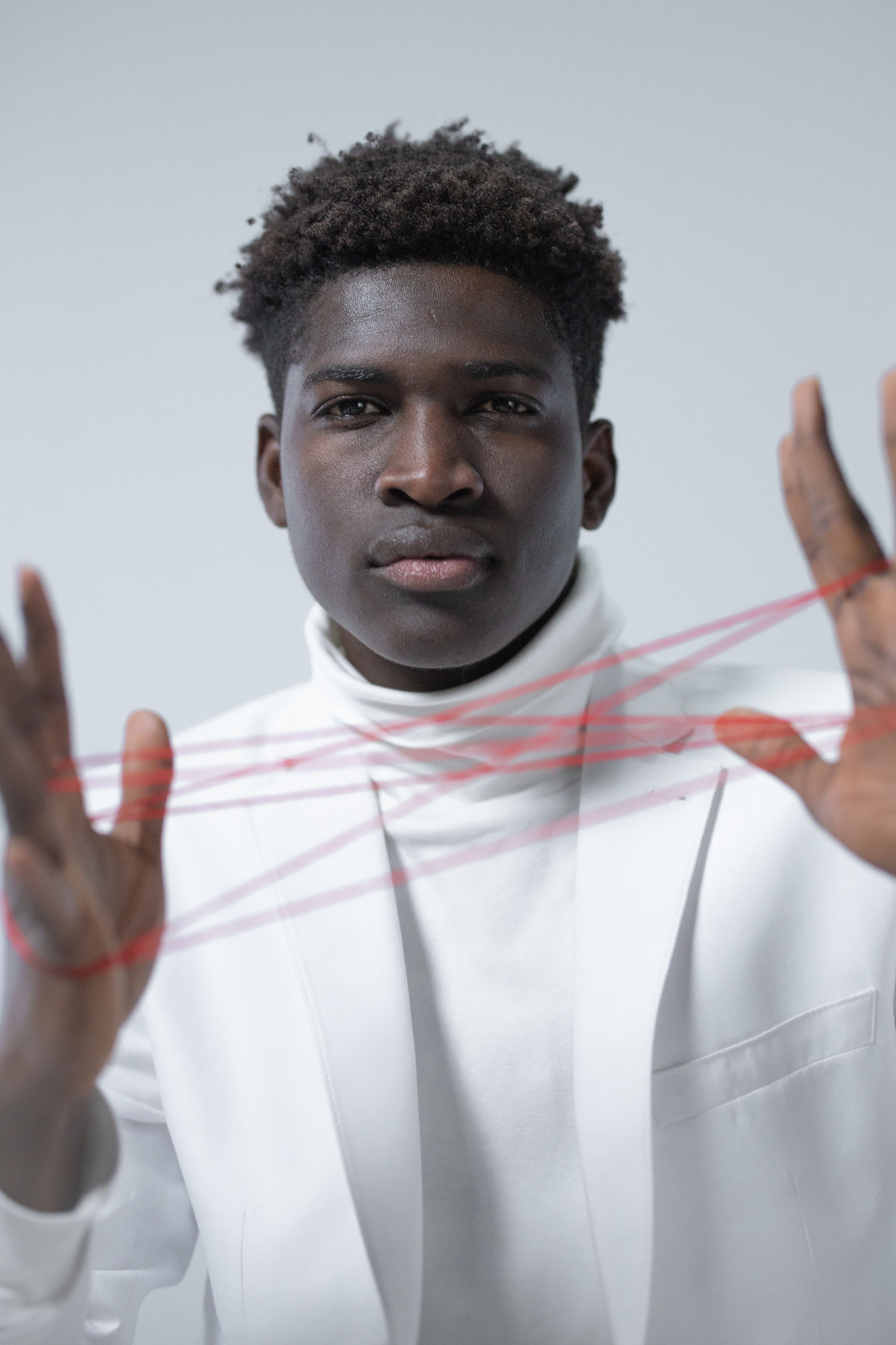 Portrait of Man in White Suit Holding Thread · Free Stock Photo