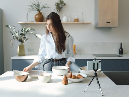 A Blogger Looking at Ceramic Bowls on a Kitchen Counter Top