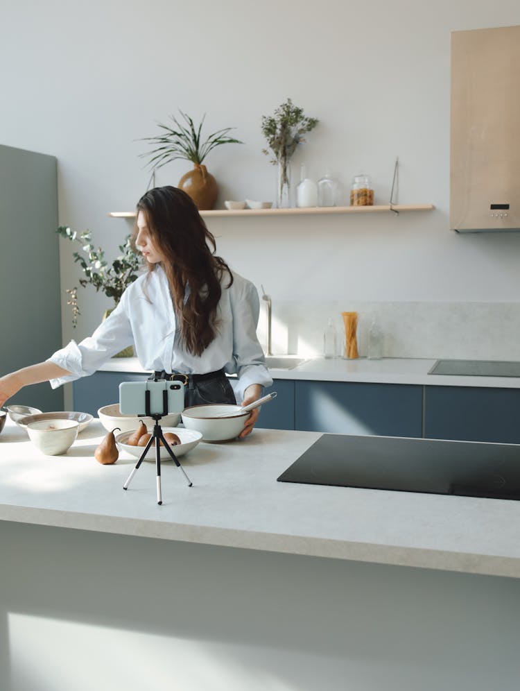 Brunette Woman Recording Herself Cooking In Kitchen