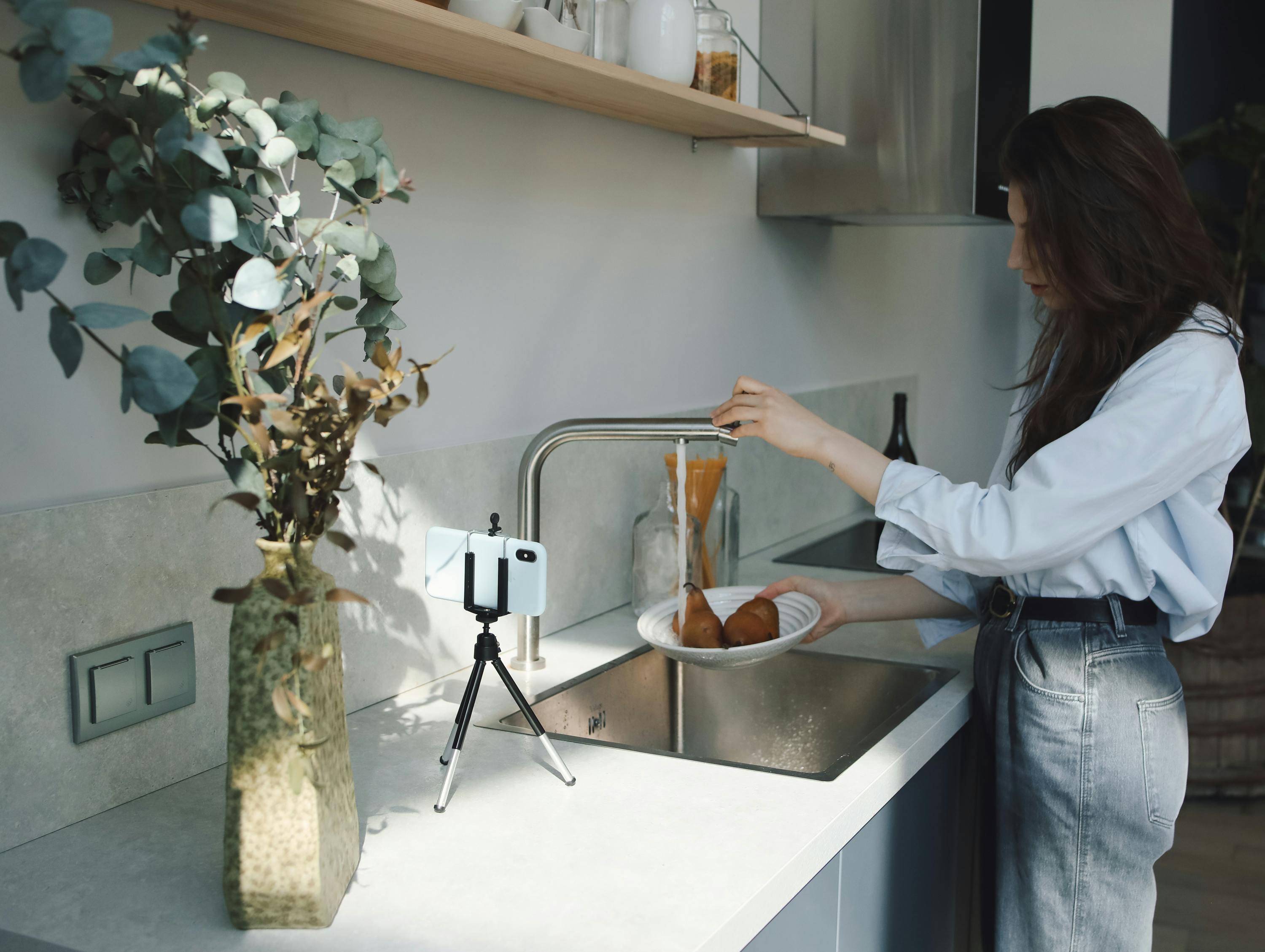 woman washing the potatoes on plate