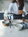 Woman in White Long Sleeve Shirt Holding White and Black Coffee Maker