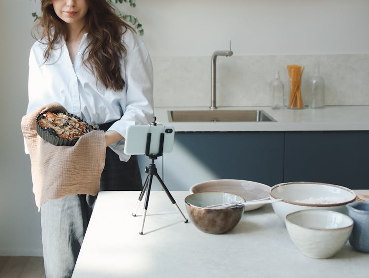 A Woman Blogging While Cooking