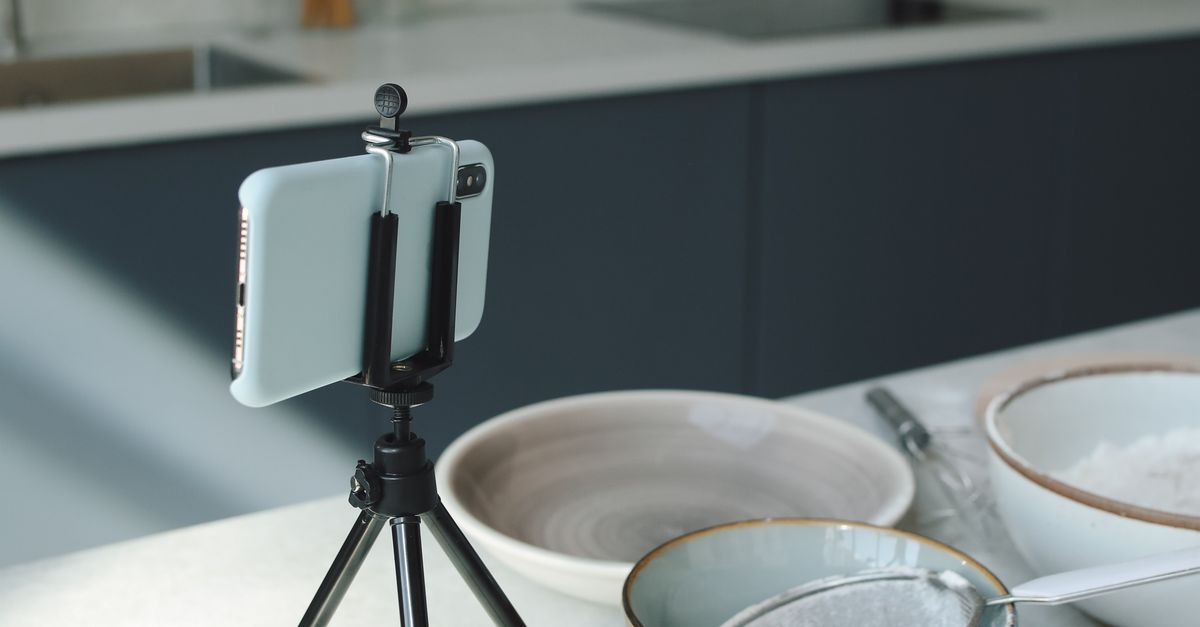 Mobile In Table A Smartphone with Tripod and Bowls on the Table · Free Stock Photo