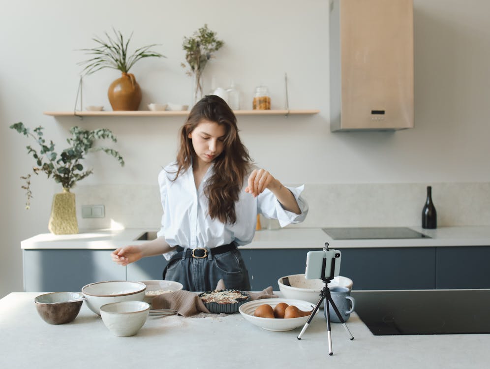 Woman in White Long Sleeve Shirt Preparing Food · Free Stock Photo