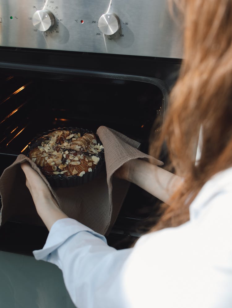 Woman Putting Food Into Oven