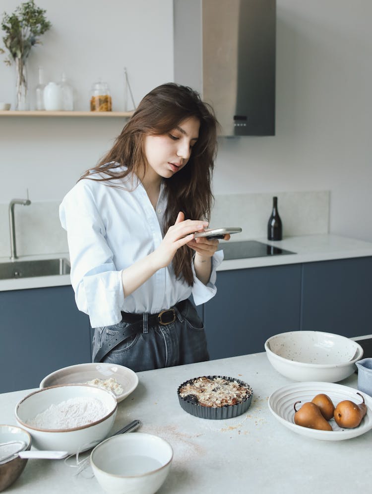 A Woman Taking Photo Of A Food