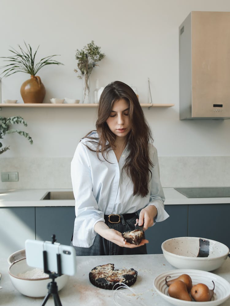 A Woman Holding A Slice Of Pie