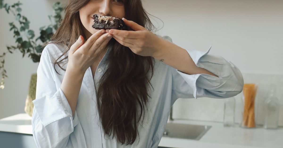 Smelling Delicious Woman Smelling Sliced Chocolate Cake · Free Stock Photo