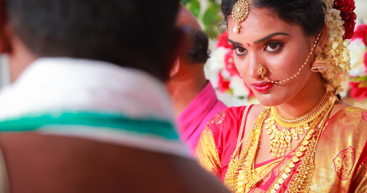 Bride in a red and gold silk sari with traditional jewellery (Temple Wedding Catering in Vellore)