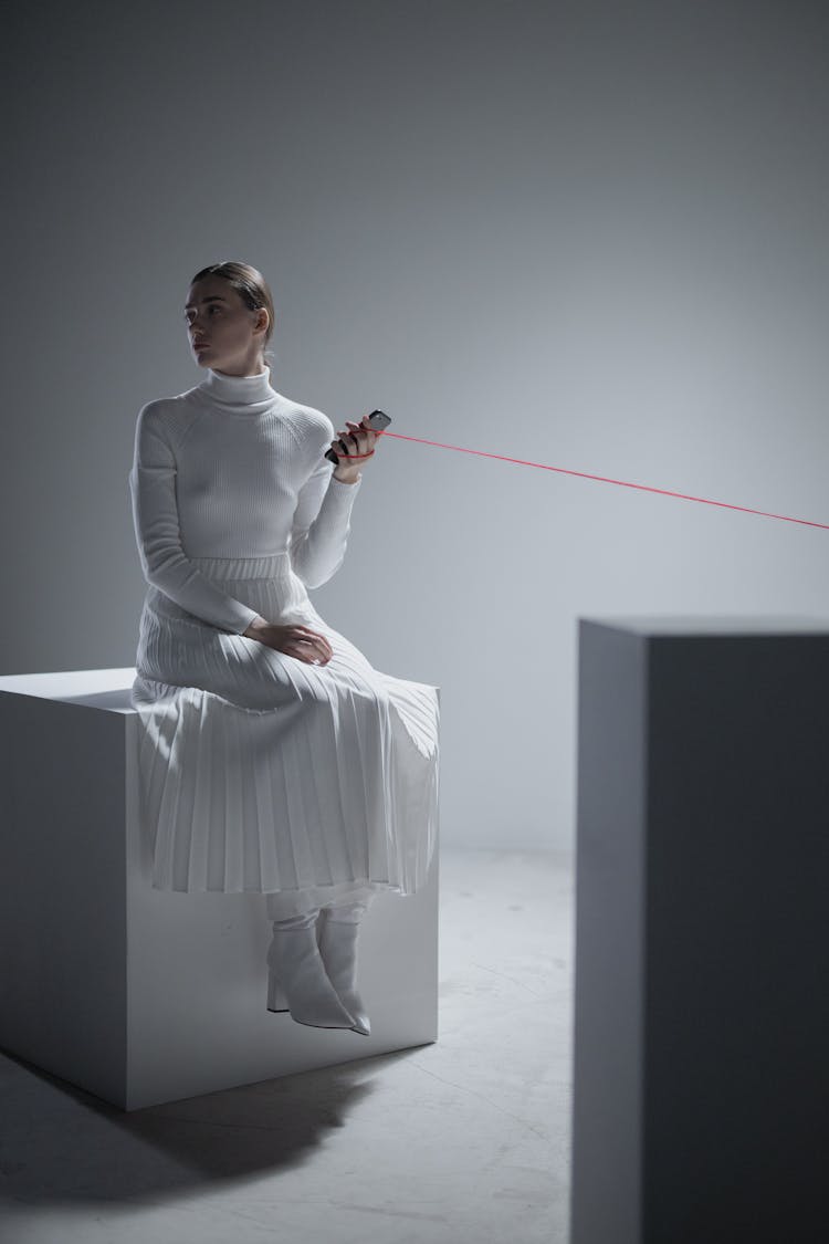 Brunette Woman Holding Phone Tied With Red Thread