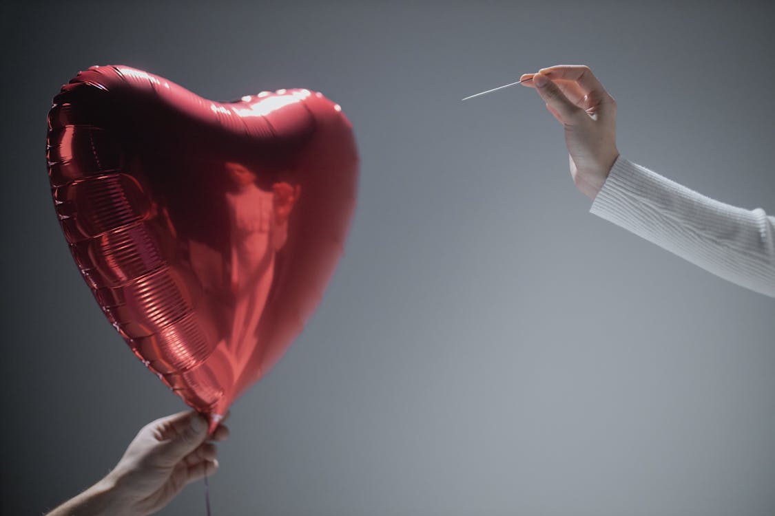 Free Person Holding Red Heart Balloon Stock Photo