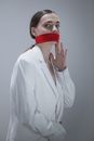 Woman in White Button Up Long Sleeve Shirt With Red Plastic Cover on Face