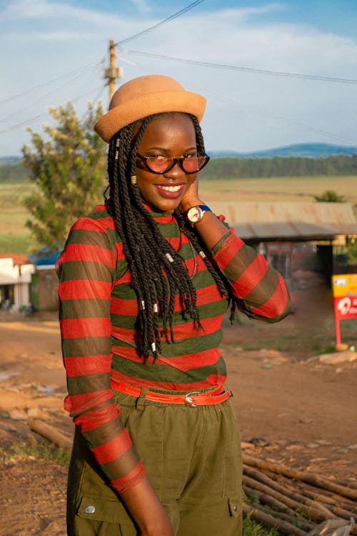 Woman in Striped Long Sleeve Shirt Wearing a Brown Hat