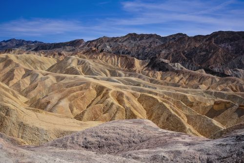 Free Vast panoramic view of the arid and eroded landscape at Zabriskie Point, Death Valley. Stock Photo