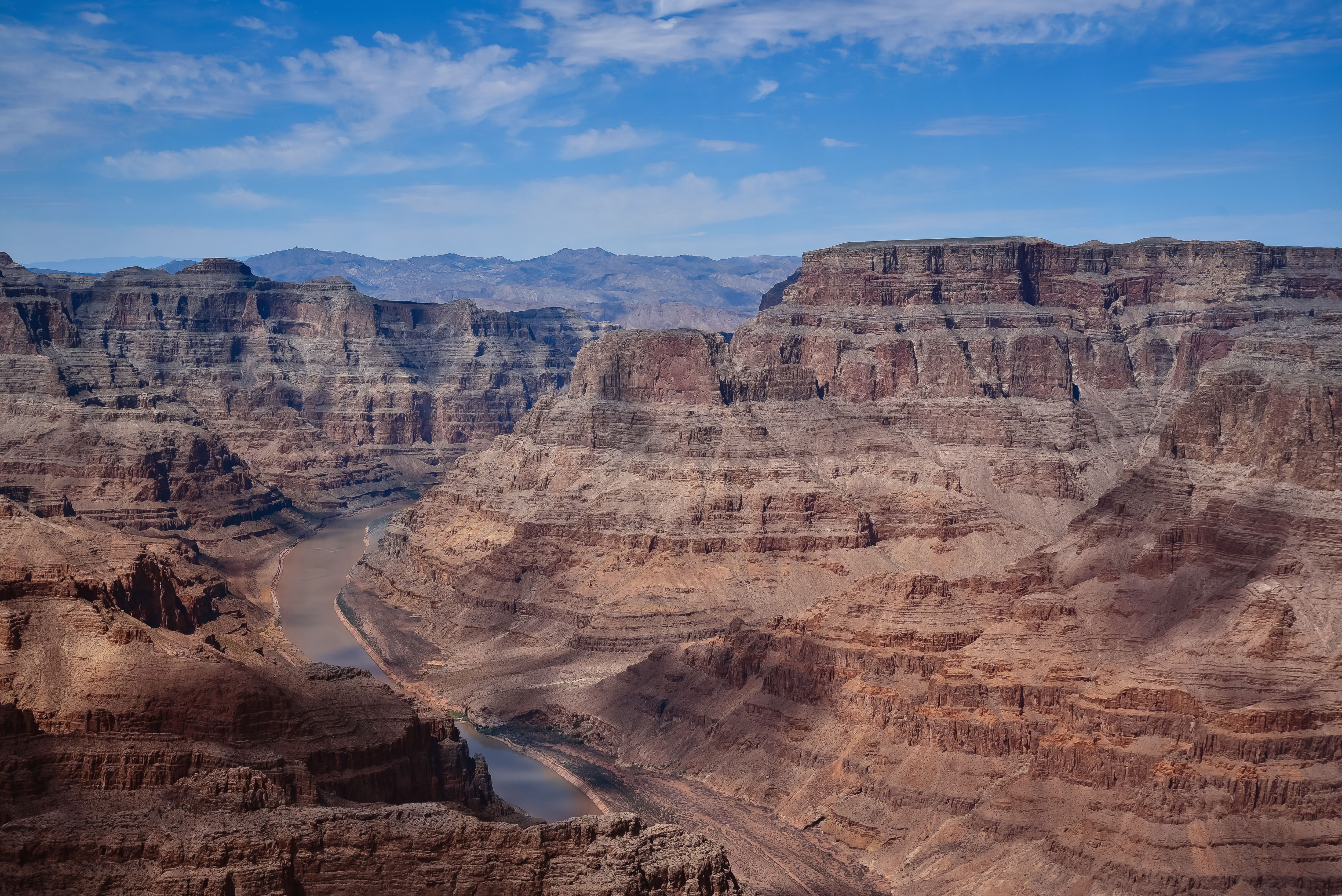 Grand Canyon West Rim Luxury Helicopter Tour from Las Vegas - Stunning aerial shot of the Grand Canyon showcasing majestic rock formations under a vibrant blue sky.