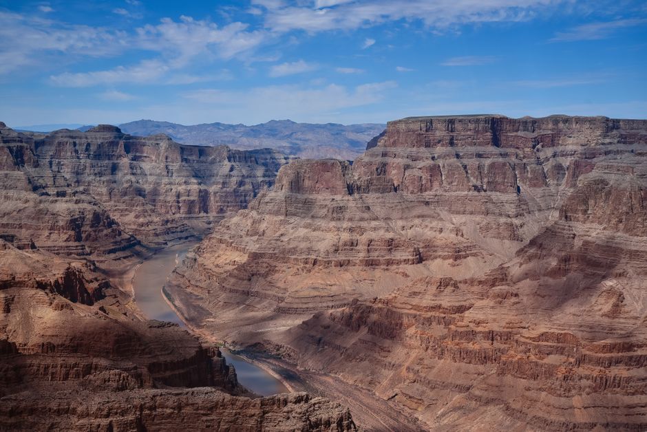 Grand Canyon West Rim Luxury Helicopter Tour from Las Vegas - Stunning aerial shot of the Grand Canyon showcasing majestic rock formations under a vibrant blue sky.