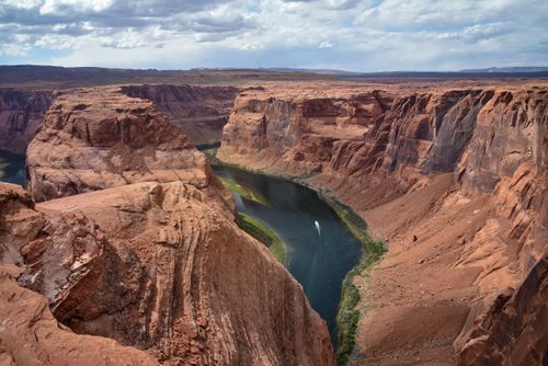 Free Breathtaking aerial shot of Horseshoe Bend's iconic river curve in Arizona's desert landscape. Stock Photo