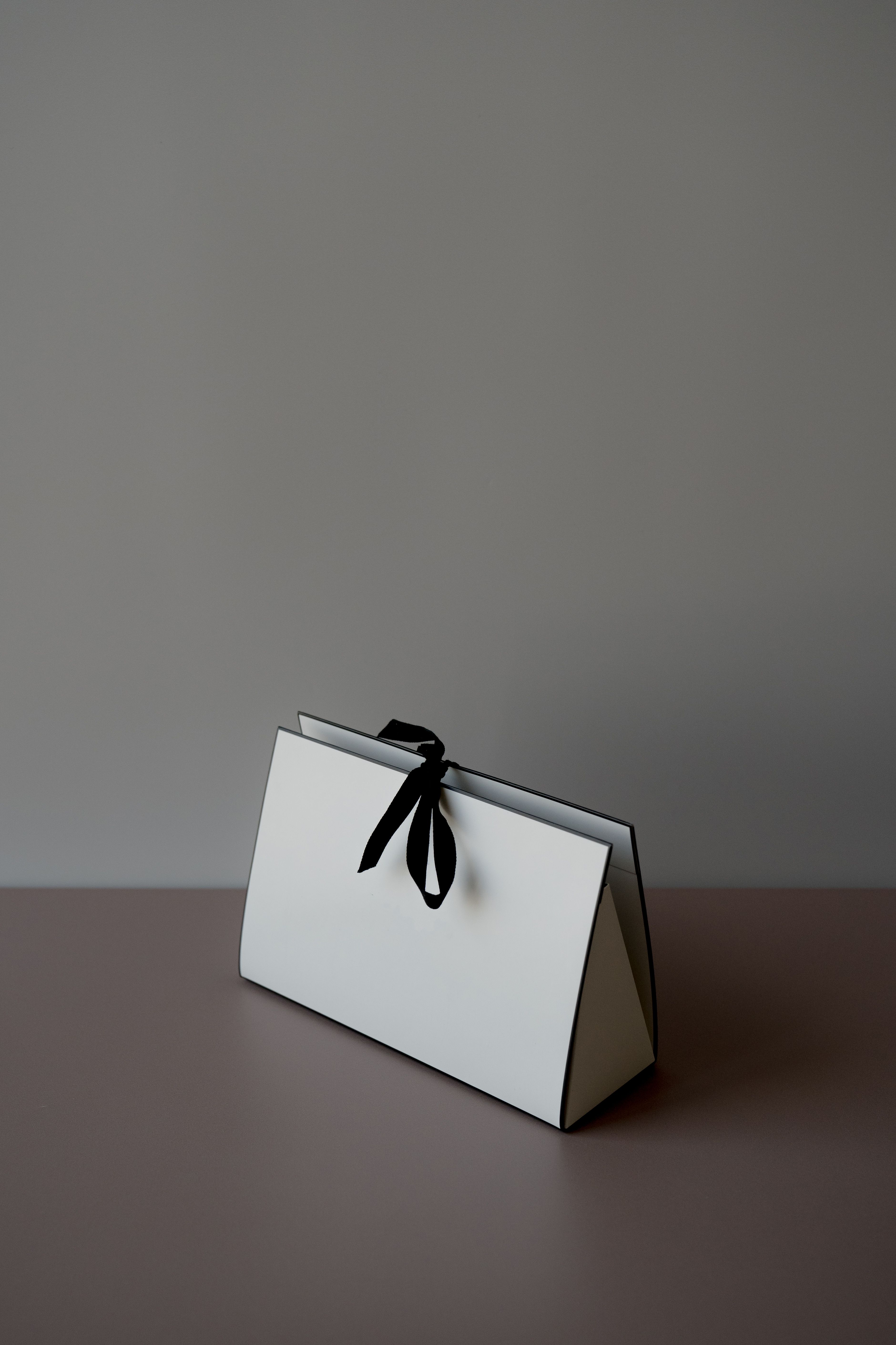 A white box tied with black ribbon