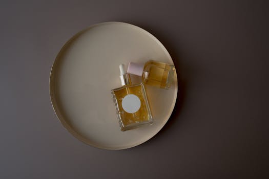 Stylish perfume bottles on a round tray, perfect for product photography or branding.