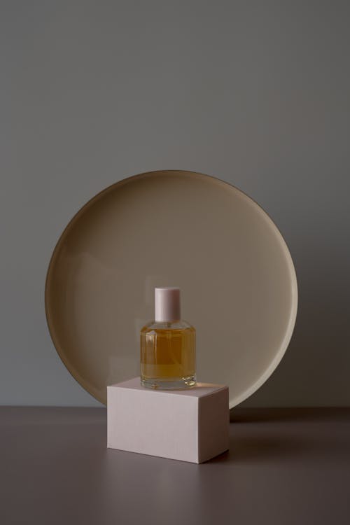 A Perfume Bottle over a White Box
