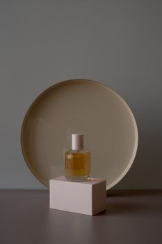 Minimalist perfume bottle on a pedestal with a modern aesthetic. Perfect for product showcases.
