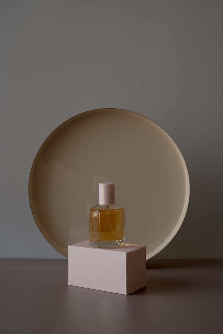 A Perfume Bottle Over A White Box