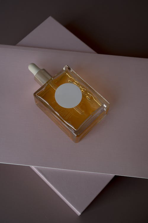 Perfume Bottle on Top of a Folder