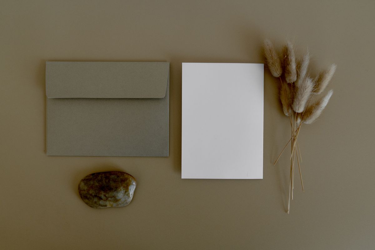 Baby shower invitation ideas with a blank minimalist card beside an envelope