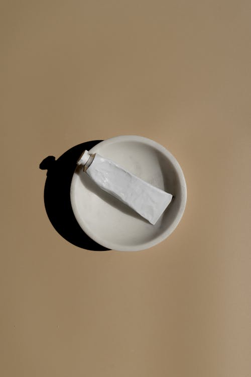 Cream Tube in White Round Bowl