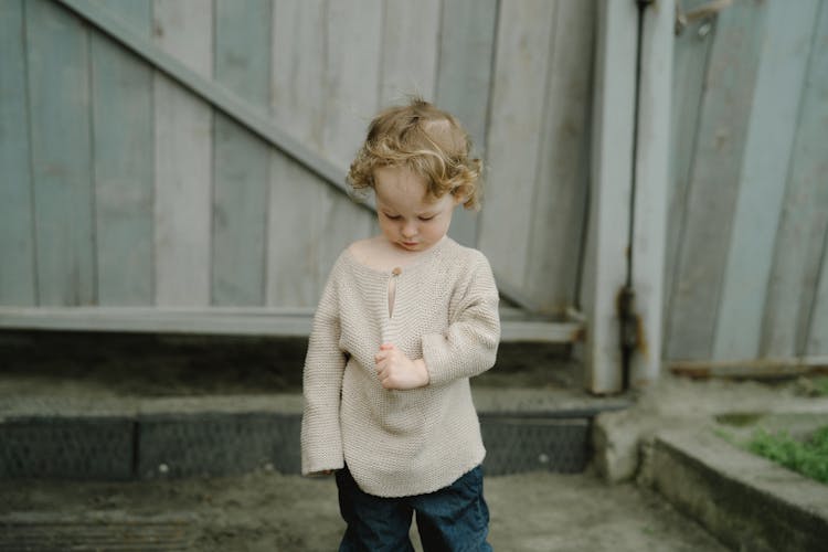 A Kid Wearing A Knitted Sweater 