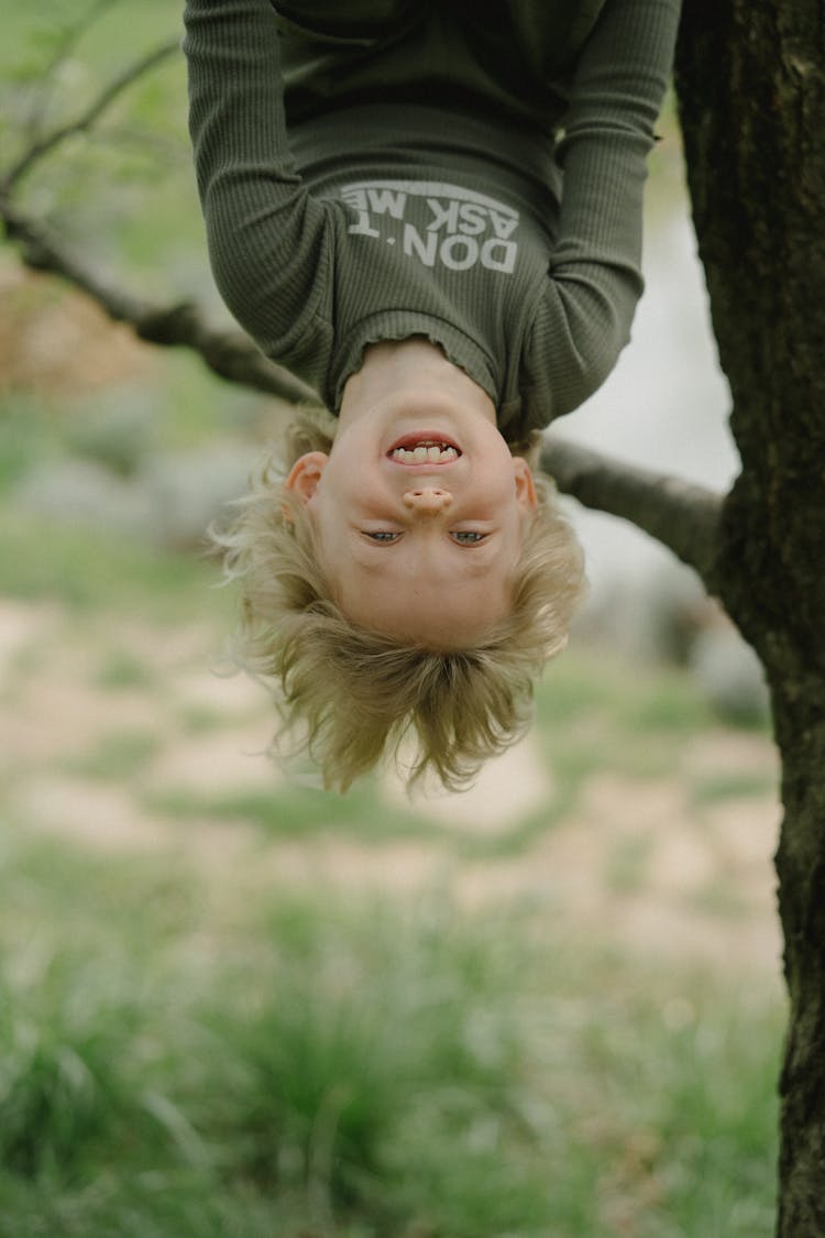 A Young Girl Climb On The Tree