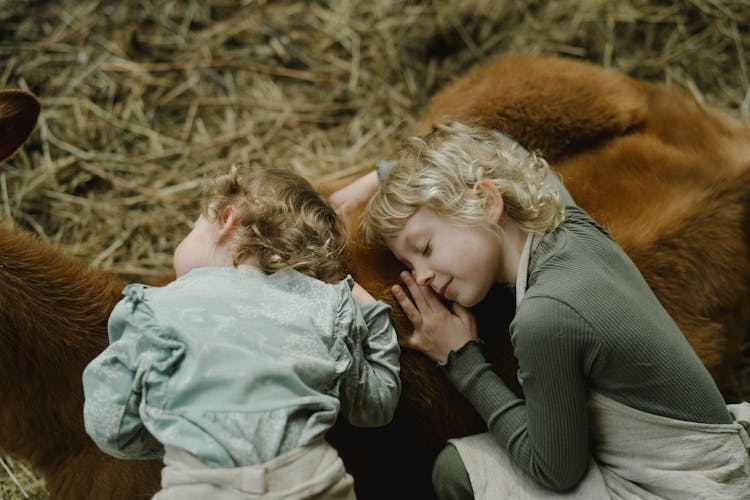 Girls Leaning On Brown Animal