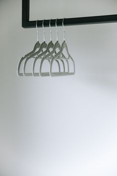 Minimalist photo of empty clothes hangers on a rack, highlighting simplicity.