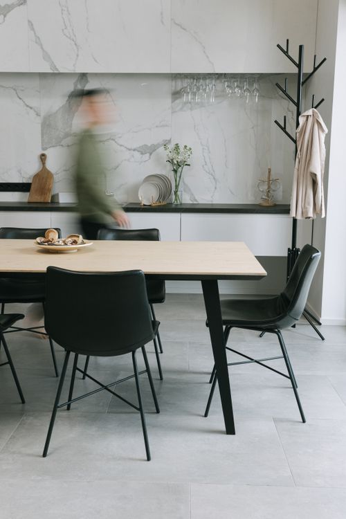 Free A stylish dining area featuring minimalist design and marble accents. Stock Photo